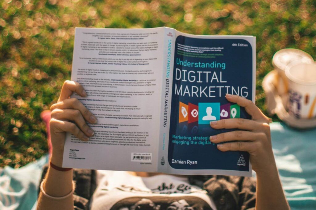 Girl reading a book about Digital Marketing