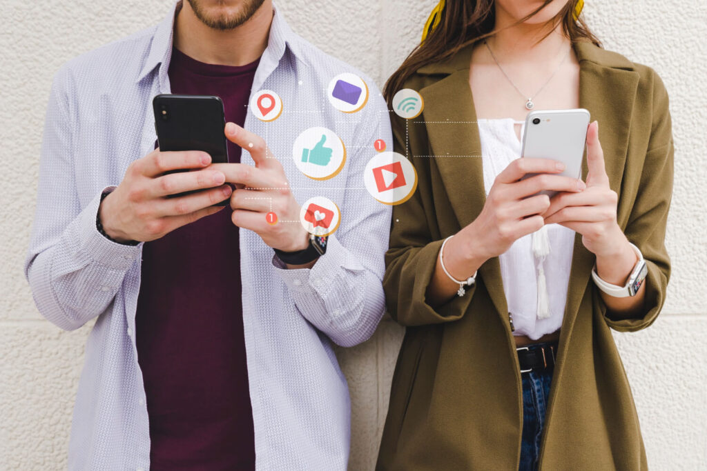 Mobile notification icons between man and woman using cell phone