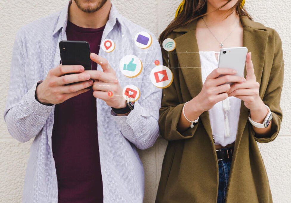 Mobile notification icons between man and woman using cell phone